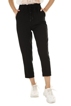 Woman wearing pants in a white studio for e-commerce fashion