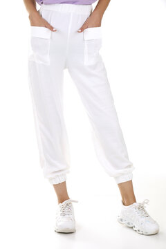Woman wearing pants in a white studio for e-commerce fashion