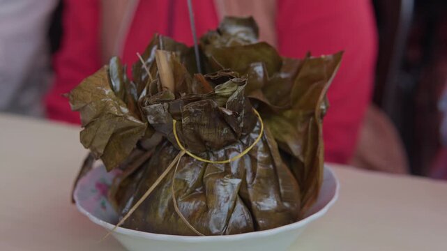 Traditional colombian tamale wrapped in leaves