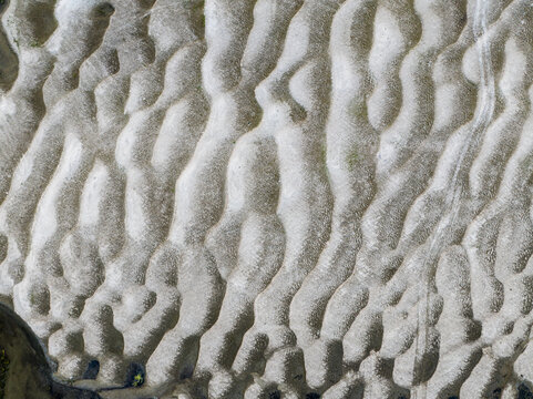 Aerial view of sand ripples and silt patterns on a riverbank in Bogura, Rajshahi Division, Bangladesh.