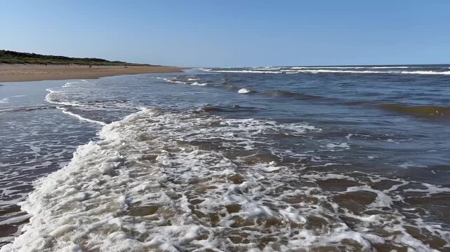 Waves breaking and rolling up the beach at Mablethorpe in Lincolnshire, UK