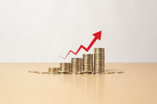 Stacked coins with rising red arrow representing inflation concept, increasing cost of living, economic pressure, financial instability, money depreciation, and macroeconomic inflation trend