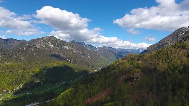 Aerial view of the Triglav mountain range with lush green valleys and forests near Mojstrana, Jesenice, Slovenia.
