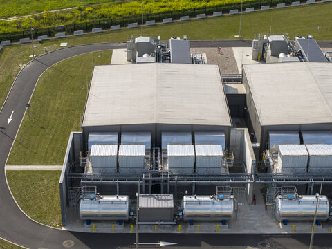 Aerial view of ai data center power generator system with industrial cooling units and large fuel tanks in a secure facility in Poland.