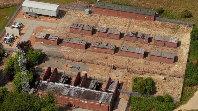 Aerial view of National Grid Sundon Substation and battery energy storage systems with electrical infrastructure and fenced perimeter in Chalton, England, United Kingdom.