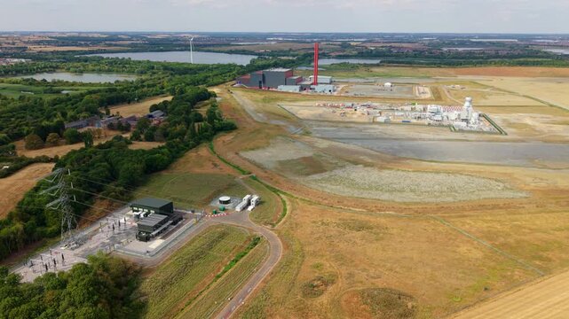 Aerial view of the National Grid 400kV Substation Marston Vale featuring industrial power infrastructure surrounded by rural fields and trees in Bedford, England, United Kingdom.