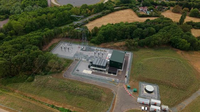 Aerial view of National Grid 400kV Substation Marston Vale surrounded by green trees and fields in Bedford, England, United Kingdom.