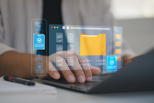 Digital folder management system on laptop screen showing file organization and data storage. Businessman in virtual office workspace for efficient online document archiving and business productivity.