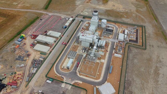 Aerial view of Millbrook Power Plant featuring industrial facilities, storage tanks, and access roads located in Stewartby, England, United Kingdom.