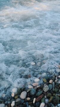 Mediterranean Waves Washing Over Coastal Pebbles