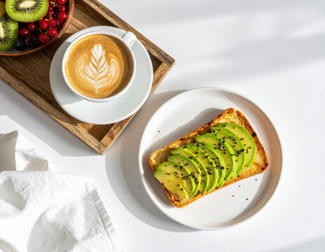 Avocado toast, coffee, and fruit arranged on wooden tray and white plate, creating bright breakfast scene with fresh ingredients, artistic latte foam, and crisp sunlight for cheerful mood