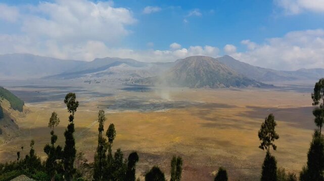 Aerial view of the volcanic landscape of Mount Bromo with its vast caldera and surrounding hills in Tosari, East Java, Indonesia.