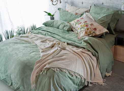 cozy pillows with blankets, bedspreads, pillowcases on a large double bed