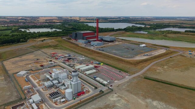 Aerial view of the Rookery South ERF and Millbrook power plant facility with its tall red chimney and surrounding industrial landscape in Stewartby, England, United Kingdom.