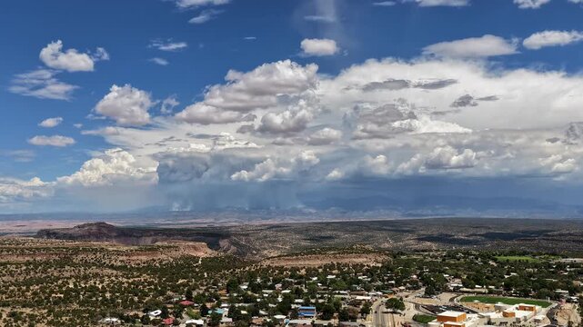 Aerial view of the eastern edge of White Rock with smoke from the Frijoles fire rising over the mountain landscape and a dust devil plume, White Rock, NM, United States.