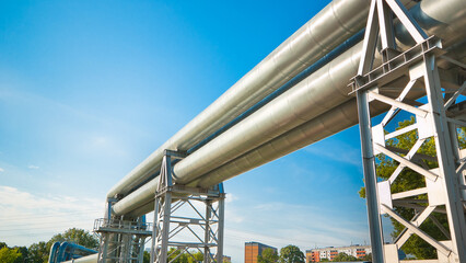 Fototapeta premium The photograph shows a pipeline on metal supports against a blue sky
