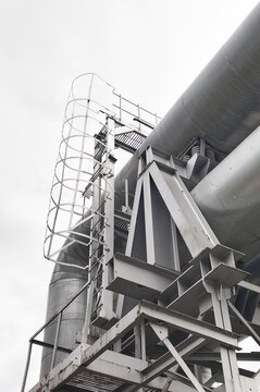 The photo shows a pipeline against a gray sk