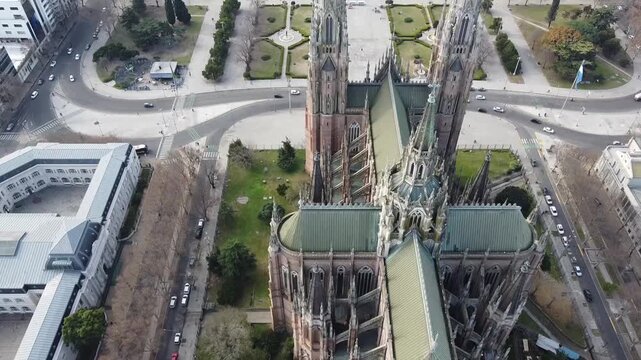 Aerial drone shot moving over the Cathedral towers revealing Plaza Moreno in La Plata, Argentina