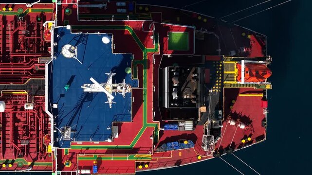 Aerial view of the industrial deck of a fuel oil tanker ship with pipes, walkways, and equipment at the Fuel Oil Terminal in Manggis, Bali, Indonesia.