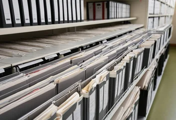 Rows of organized files and binders in a modern archive or office storage room © RYOTA IWASAKI