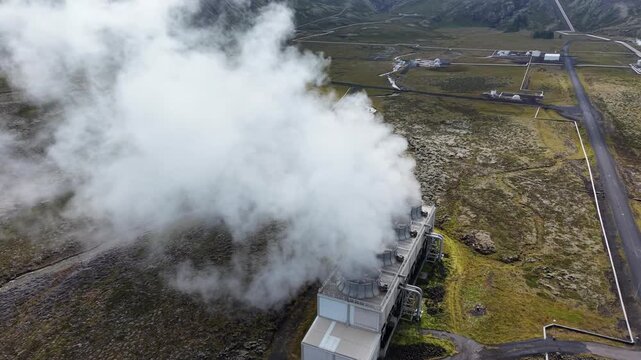 Aerial view of Nesjavellir Geothermal Power Station emitting steam over the volcanic landscape in Selfoss, Grimsnes- og Grafning, Iceland.