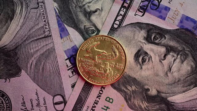 Gold coin macro close up of 1/4oz  eagle 10 dollars macro moving spotlight, red light indicating mood, authentic gold close up, contrast	
