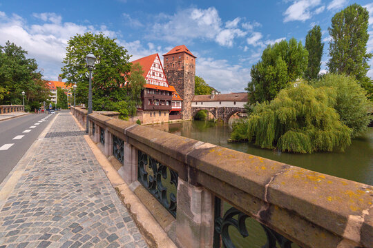 Historic riverside buildings, stone tower and bridges along the Pegnitz River in Nuremberg, Germany.
