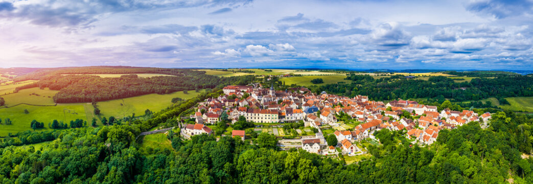 Aerial view of Flavigny-sur-Ozerain, in the Cote-d'Or department of Bourgogne-Franche-Comte in France, is a medieval fortified village known for its stone alleys, ramparts, abbey and anise candy.