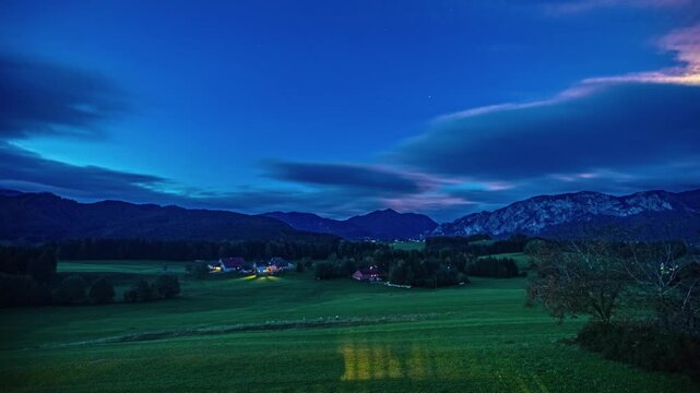 Stunning sunrise time lapse over alpine meadow landscape in bavaria featuring rolling hills and dramatic cloud formations.