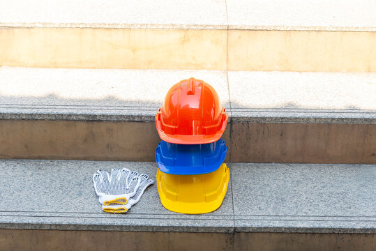 Orange blue white and yellow helmets safety diversity engineering concept