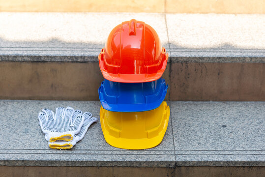 Orange blue white and yellow helmets safety diversity engineering concept
