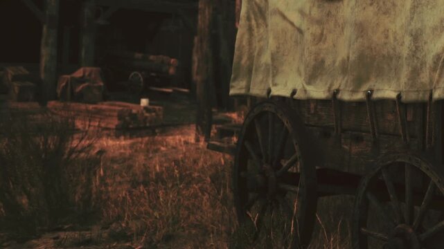 A wooden wagon stands on grass in a field. The sun sets, casting warm light on the scene. Nearby are trees and some tools scattered on the ground. It captures a moment in a rural setting.