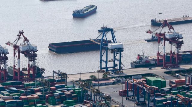 Loading and unloading of heavy shipping containers at the busy Banjarmasin port facility