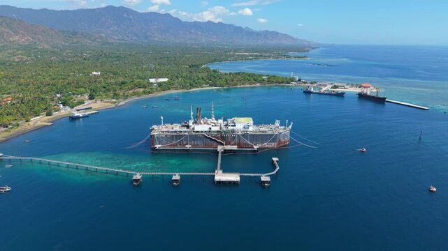 Aerial view of the Cinta Natomas floating storage and offloading ship moored in the clear blue waters of Buleleng Regency, Bali, Indonesia.