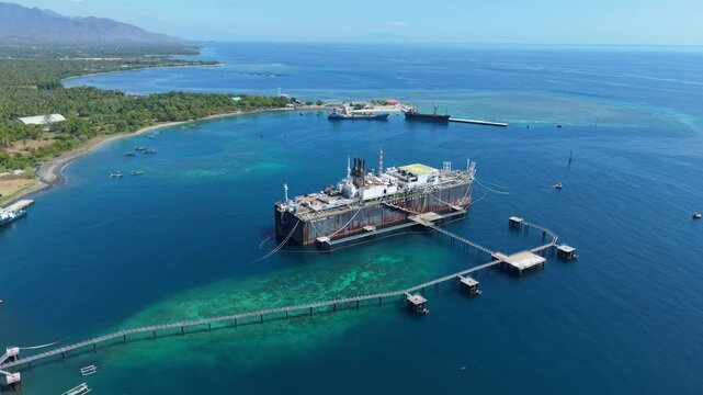 Aerial view of the Cinta Natomas floating storage and offloading ship moored in the clear blue waters of Buleleng Regency, Bali, Indonesia.