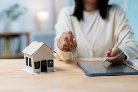 Home Buying and Real Estate Ownership Concept with House Model and Key