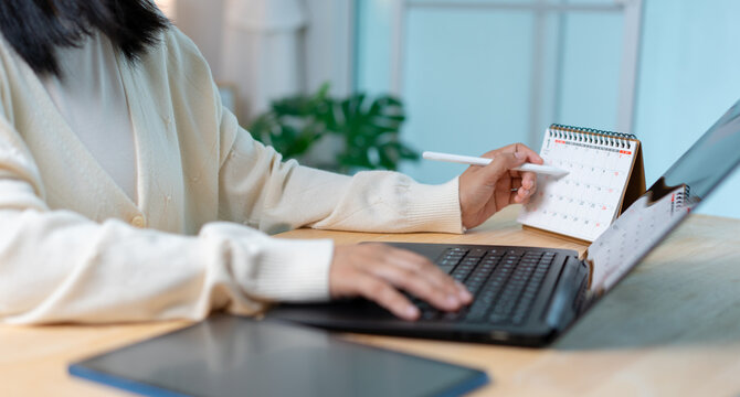 Woman Planning Schedule with Calendar, Tablet and Laptop