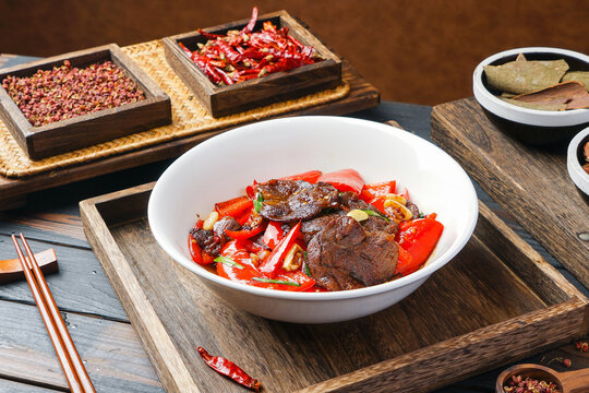 Spicy stir-fried beef with red bell peppers in a bowl