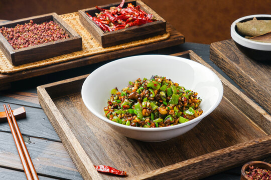 Spicy stir-fried mushrooms with green peppers and chili in a white bowl