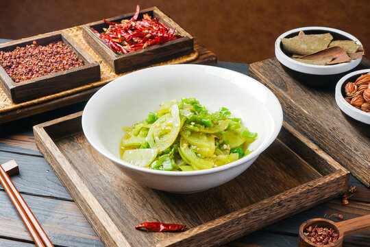 Stir-fried green pepper and squash slices in a white bowl
