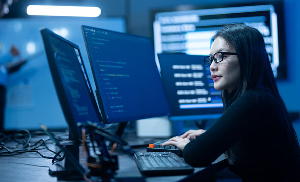 Programmer professional female working on software development, Asian IT developer coding for SaaS platform and cybersecurity network, Modern technology and computer programming business concept