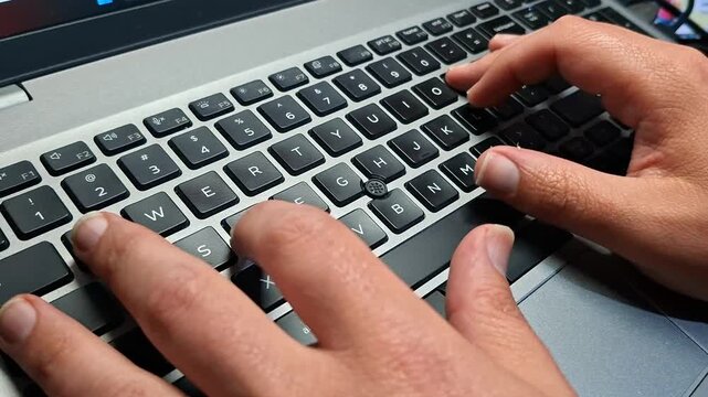 Close-up of professional typing on laptop keyboard in home office environment. Concept of remote work, freelance lifestyle, digital business, productivity and online communication. 
