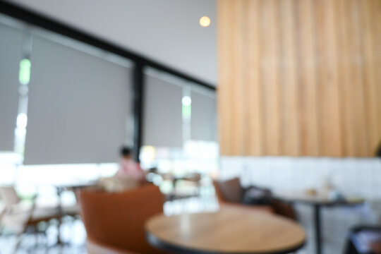softy blurred view of a modern cafe or lounge interior featuring comfortable chair and round table