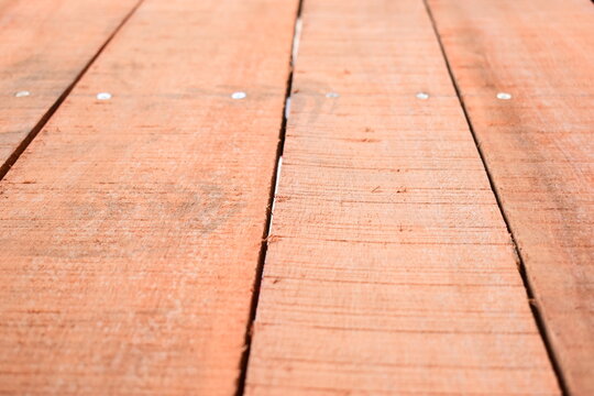 natural reddish brown wooden board texture background with visible screw