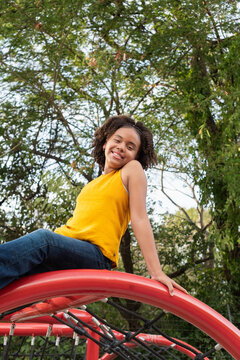 Girl smiling and playing in outdoor park playground