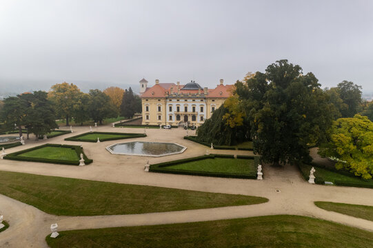 Aerial view of the historic Slavkov Castle with its manicured gardens, octagonal pond, and statues in Slavkov u Brna, South Moravian Region, Czechia.