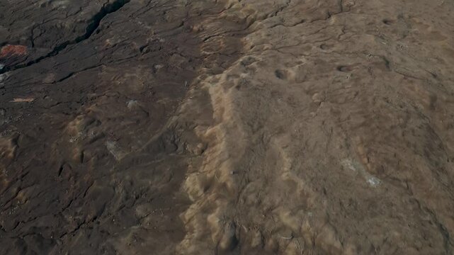 Aerial view of parched cracked desert earth terrain showcasing dry ground formations in landscape.