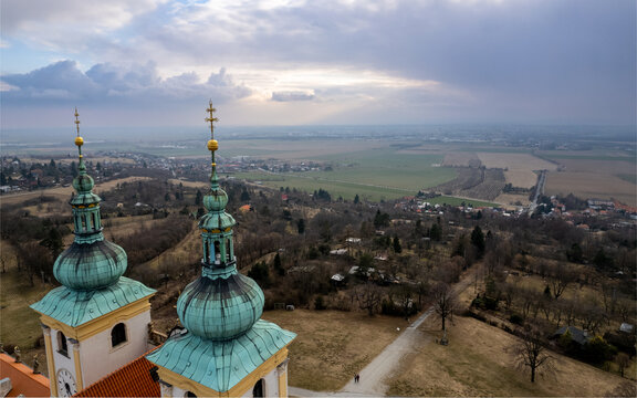 Aerial view of the Basilica of the Visitation of the Virgin Mary on Svaty Kopecek with its distinctive green onion domes overlooking the rural landscape in CZ.