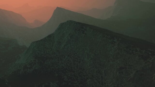 The scene shows mountains at sunset with a mixture of hills and valleys. The sky has orange and green colors, creating a rich backdrop to the rugged terrain.