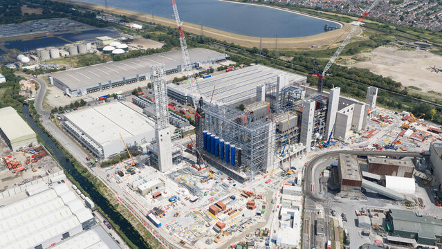 London, England, United Kingdom - 16 July 2026: Aerial view of a large industrial construction site featuring multiple cranes, steel structures, and storage tanks.